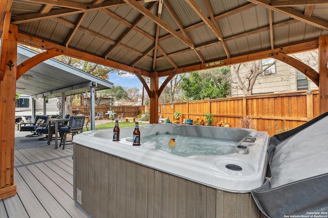 wooden terrace with a gazebo and a hot tub