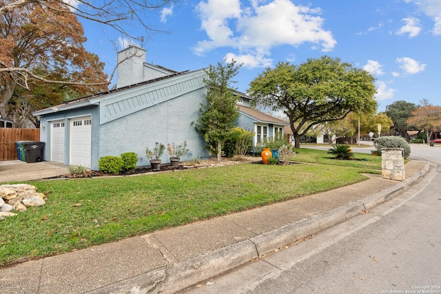 view of side of home with a lawn and a garage