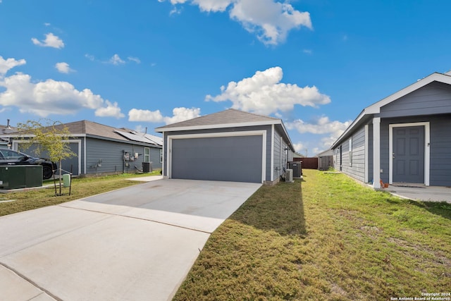 view of side of property featuring a yard, a garage, and central air condition unit