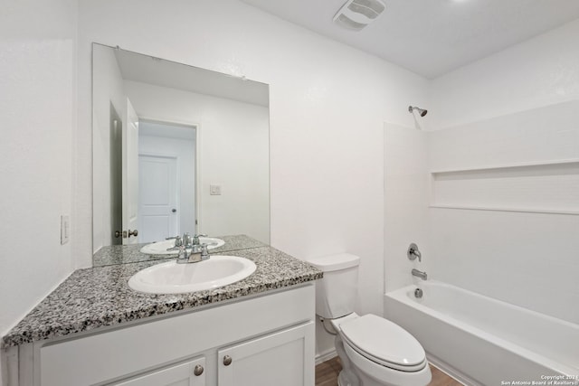 full bathroom with shower / bathing tub combination, vanity, hardwood / wood-style flooring, and toilet