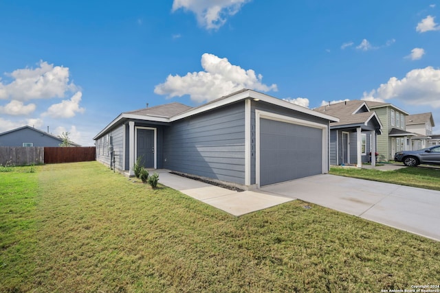 ranch-style house featuring a front yard and a garage