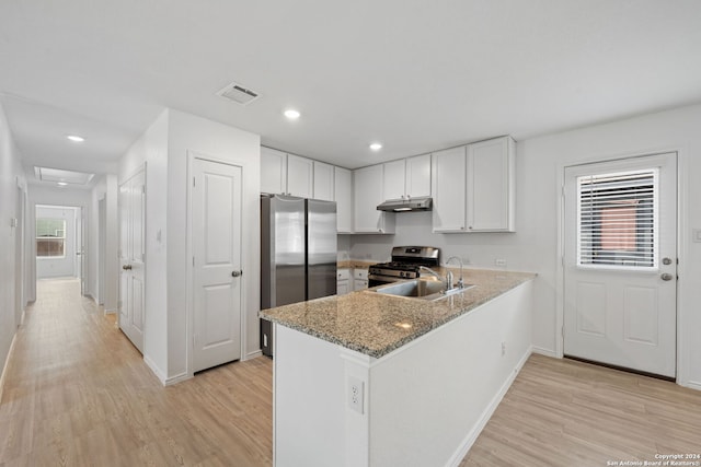 kitchen with white cabinetry, sink, stainless steel appliances, and light stone counters