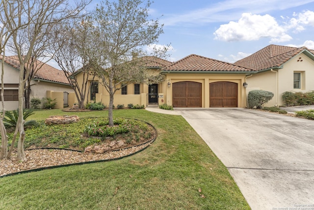 mediterranean / spanish house featuring a front yard and a garage