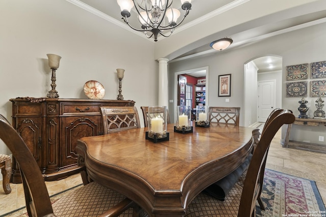 dining space with a chandelier, ornate columns, and ornamental molding