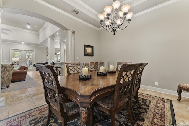 tiled dining room featuring a raised ceiling, ornate columns, crown molding, and a chandelier