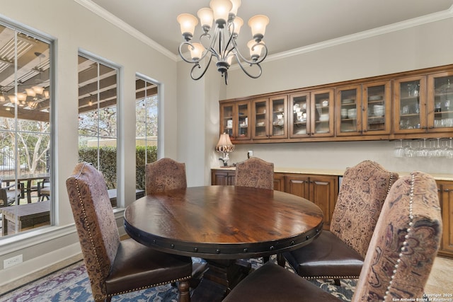 dining room with crown molding and a notable chandelier