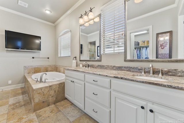 bathroom with tiled tub, a wealth of natural light, crown molding, and vanity