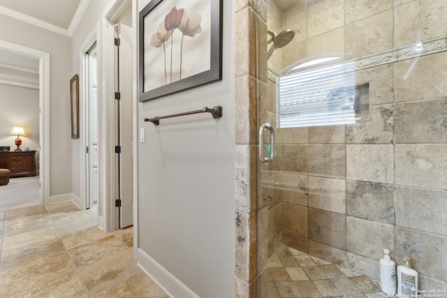 bathroom featuring a shower with door and ornamental molding