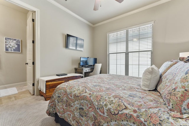 carpeted bedroom with ceiling fan and ornamental molding