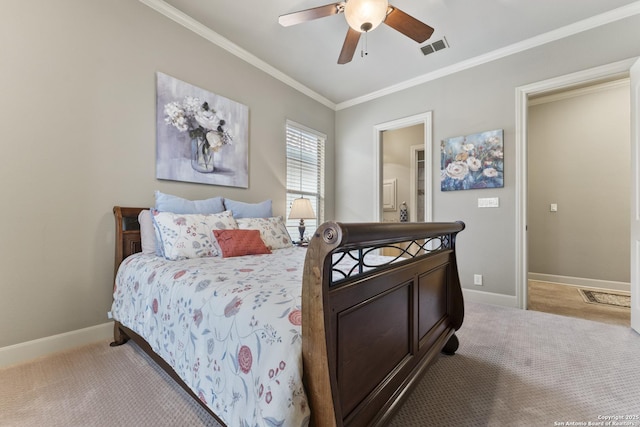 carpeted bedroom featuring ceiling fan and crown molding