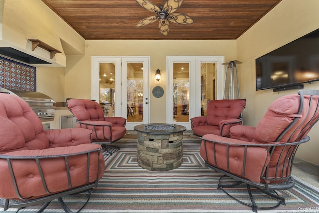 living room with ceiling fan, french doors, wood ceiling, and vaulted ceiling