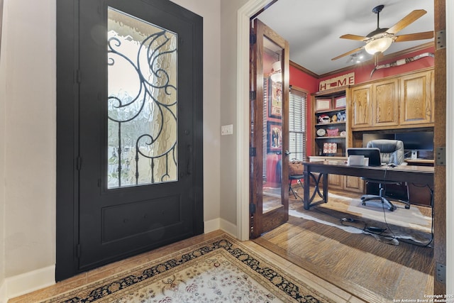 foyer featuring french doors, ceiling fan, and crown molding