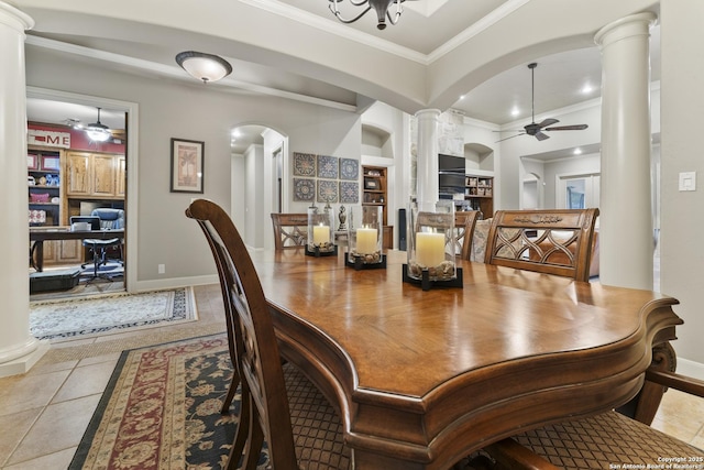 tiled dining space featuring decorative columns, crown molding, built in features, and ceiling fan