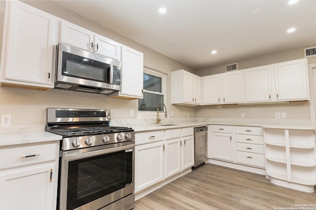 kitchen featuring white cabinets, appliances with stainless steel finishes, and sink