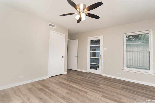 empty room with light hardwood / wood-style flooring and ceiling fan