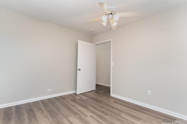 spare room with wood-type flooring and ceiling fan