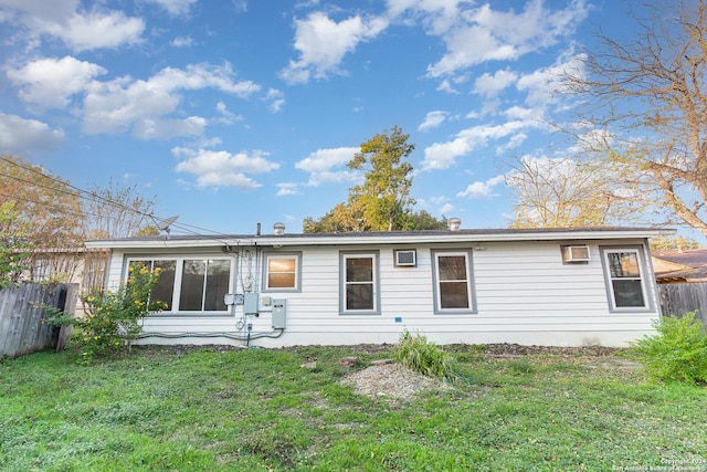 back of house featuring a yard