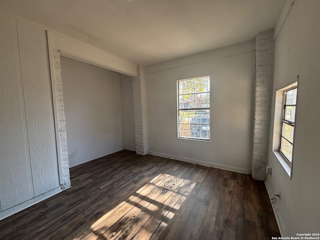 spare room featuring dark hardwood / wood-style floors