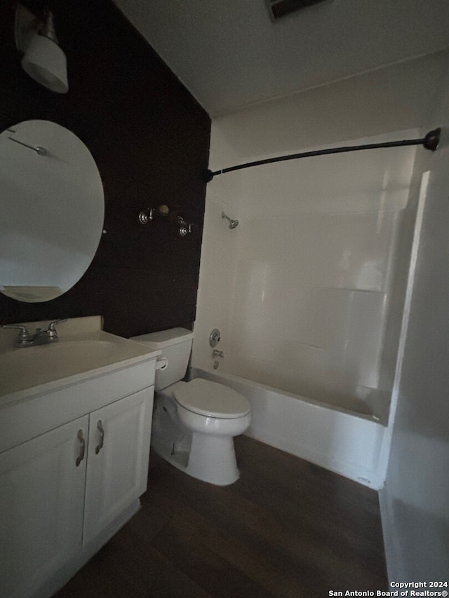 full bathroom with wood-type flooring, vanity, toilet, and tub / shower combination