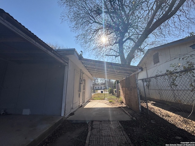 view of side of home with a carport