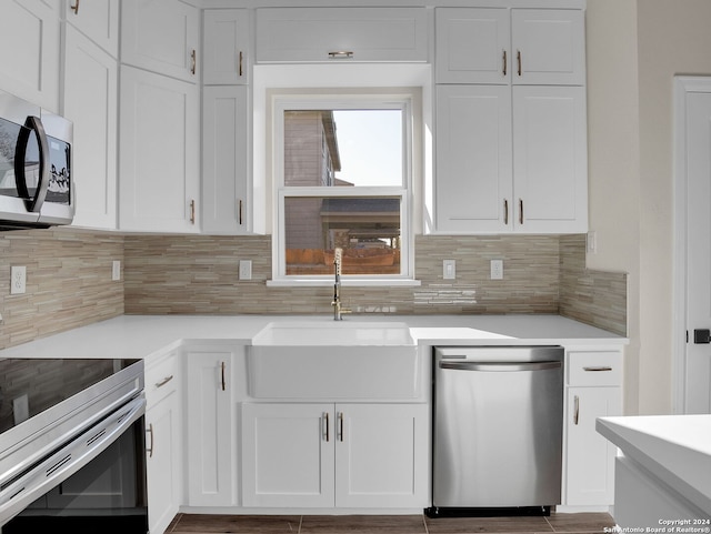 kitchen with white cabinetry, sink, appliances with stainless steel finishes, and tasteful backsplash