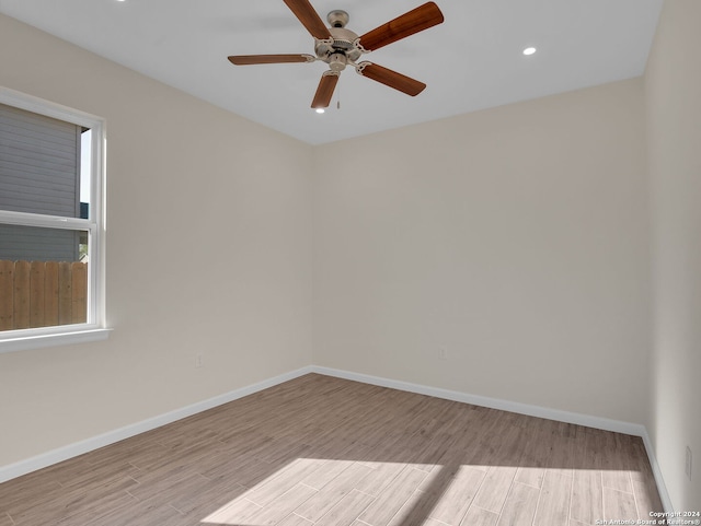 spare room with light hardwood / wood-style flooring and ceiling fan