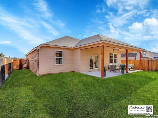 rear view of property featuring outdoor lounge area, french doors, a patio, and a yard