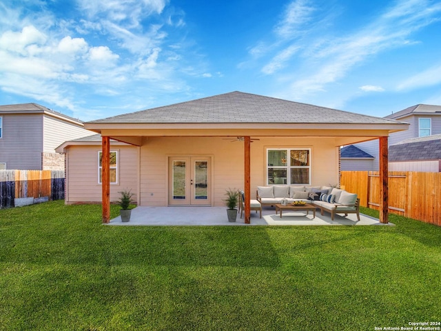 rear view of house featuring a lawn, ceiling fan, french doors, an outdoor living space, and a patio