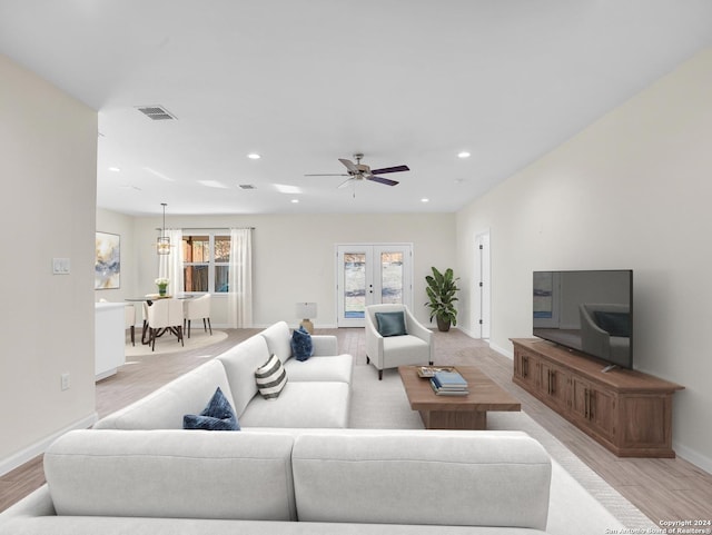 living room with light hardwood / wood-style floors and ceiling fan