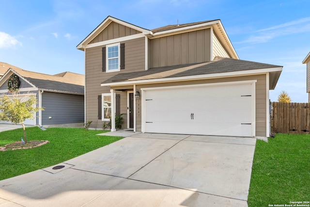 view of front of home with a garage and a front lawn