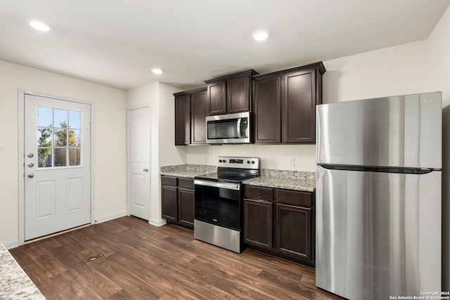 kitchen featuring dark wood-type flooring, stainless steel appliances, and dark brown cabinets