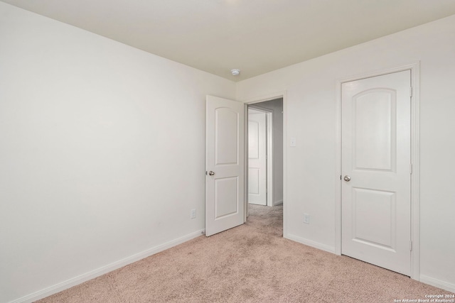 unfurnished bedroom with light carpet