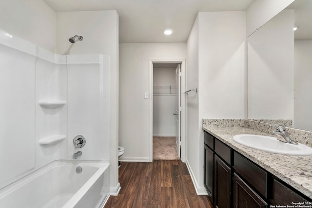 full bathroom featuring shower / bathing tub combination, vanity, hardwood / wood-style flooring, and toilet