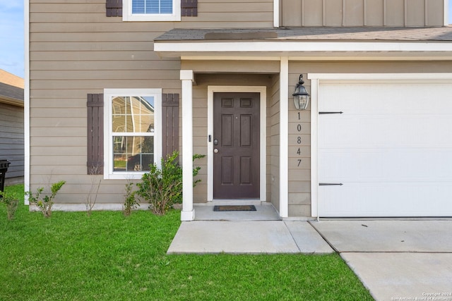 view of exterior entry with a garage