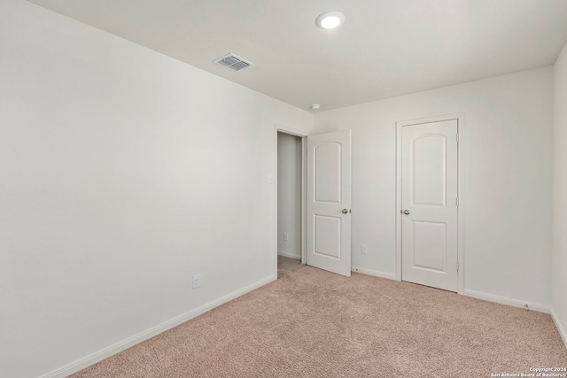 unfurnished bedroom with light carpet