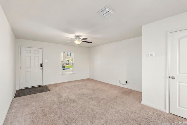 carpeted spare room with ceiling fan