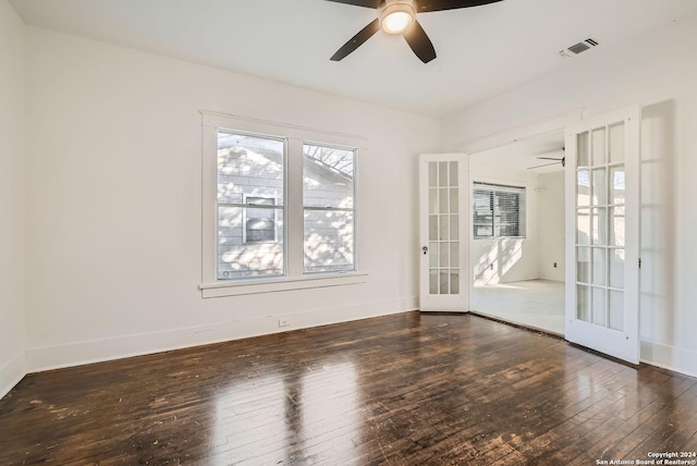 empty room featuring french doors, dark hardwood / wood-style flooring, plenty of natural light, and ceiling fan