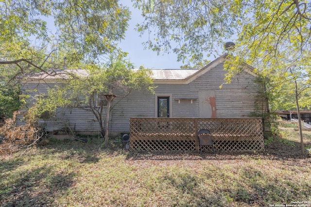 rear view of property with a wooden deck