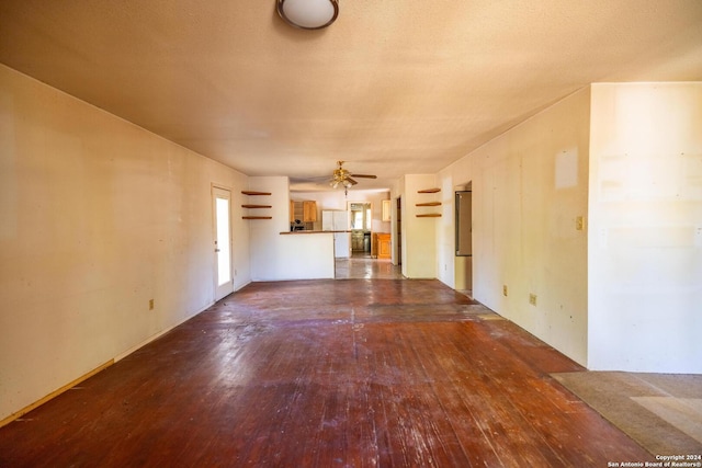 unfurnished living room featuring hardwood / wood-style floors and ceiling fan