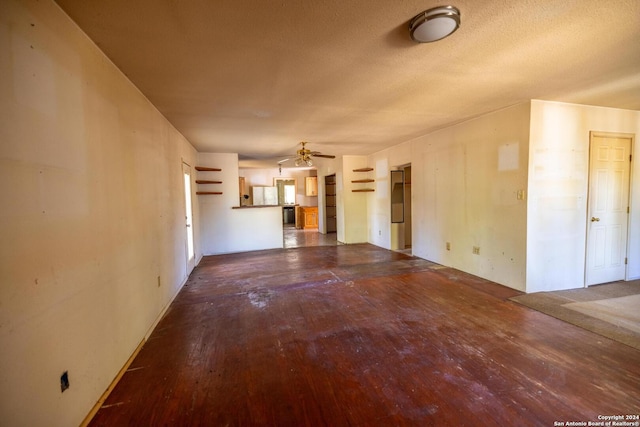 unfurnished living room with ceiling fan, wood-type flooring, and a textured ceiling