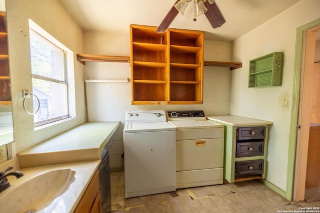 clothes washing area with ceiling fan, washer and clothes dryer, and sink