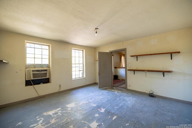 empty room with cooling unit and a textured ceiling