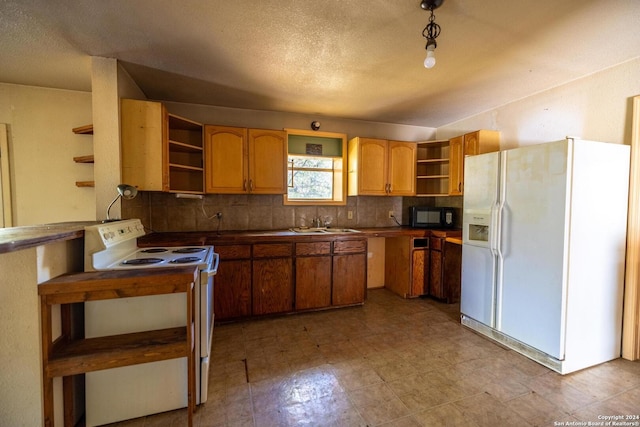 kitchen with sink, white appliances, and backsplash