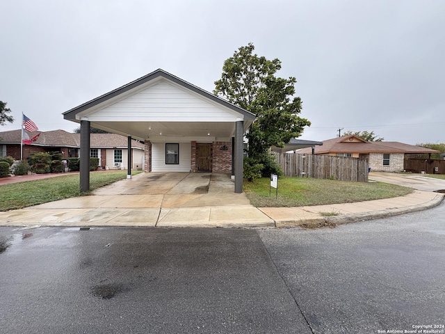 view of front of property featuring a carport