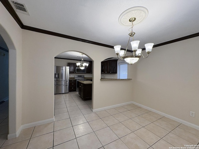 kitchen featuring dark brown cabinets, light tile patterned flooring, ornamental molding, and stainless steel appliances