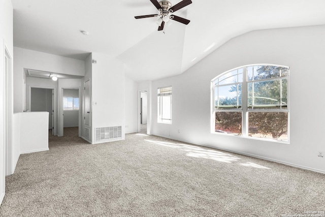 interior space with ceiling fan, plenty of natural light, carpet flooring, and lofted ceiling