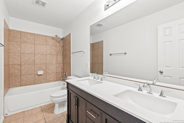 full bathroom with toilet, tiled shower / bath, tile patterned flooring, and vanity