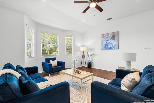 living room with ceiling fan, vaulted ceiling, and hardwood / wood-style flooring