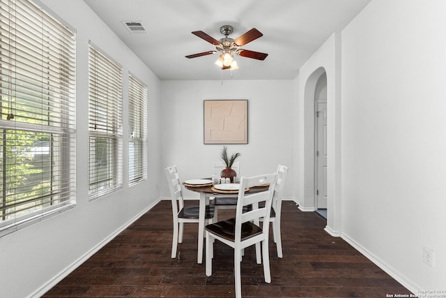 dining room with ceiling fan and dark wood-type flooring