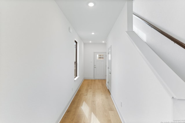 hall with baseboards, light wood-type flooring, and recessed lighting